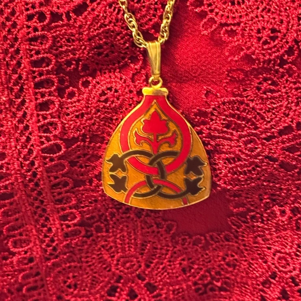 Gold tone signed Celtic knot pendant necklace in red, black and orange enamel